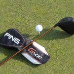Ping G400 Driver and Headcover laying on grass