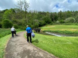 Steve King walking over a bridge on his way to the 2nd Hole Green at Manor House Golf Club In Wiltshire